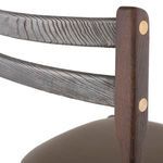 Close-up of backrest detail highlighting textured wood grain and brass fasteners
