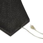 Close-up of metal cord entry on textured tapered base with clear plug attached