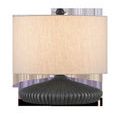 Mythmaker Table Lamp with a squashed circular terracotta base in black granite finish and a beige fabric drum shade