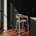 Martens counter stool placed in a dark, modern kitchen with wood flooring and natural light