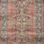 Long runner-style rug with repeated medallion pattern in spice and aqua shades