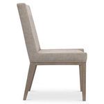 Side profile of Linea side chair with beige upholstery and light stained ash legs on white background