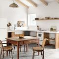 Claire Ocean Gold Rug placed in a bright kitchen with natural wood and white accents under dining table and chairs