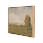 Three-quarter angled view showing light wood frame depth and texture around misty morning cabin painting