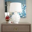 Top section of Stanford side table with decorative white lamp, gold bowl with strawberries, and mirrored wall reflection