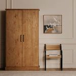 Tade cabinet closed in styled room setting beside woven chair and bird painting on wall