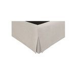 Close-up of the cream fabric skirt with crisp corner pleats at bed base