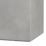 Close-up of the lower corner of the planter showing smooth vertical edge and concrete finish
