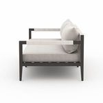 Sherwood sofa angled side view featuring detailed woven straps on armrests and back
