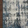 Detailed corner of Austen Ocean Rug on dark hardwood floor showing edge stitching
