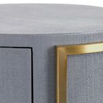 Close-up of textured heavy linen gray lacquer surface and brass trim detailing