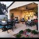 Monterey Dining Chairs with blue cushions at covered outdoor dining area with cooking grill