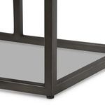 Close-up of iron frame base showing welding seams and matte gunmetal finish
