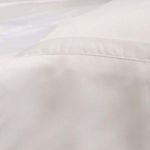 Detailed close-up of duvet edge seam showcasing fine stitching and smooth bamboo sateen fabric