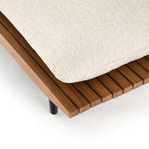 Detail of sofa wooden slatted frame corner with cushion edge and black leg beneath
