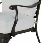 Close-up on armrest curve and wooden texture of the frame with cushion edge
