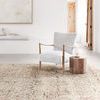 Theia Natural / Rust Rug styled in a modern bright room with chair and side table on top