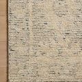 Corner of Penny Blue rug on wooden floor highlighting pile detail and subtle background motifs