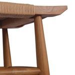 Underside view focusing on wood leg joint and bottom of woven seat