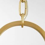 Close-up of polished brass hanging ring and chain link showing texture and finish