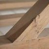 Close-up of a diagonal timber joint in the reclaimed pine wood base