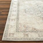 Detail shot of Lila rug corner showing machine woven edges and texture on medium-toned hardwood flooring
