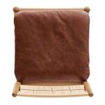 Overhead view of stool seat showing smooth brown leather cushion resting on woven natural paper cord seat base