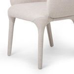 Close-up showing upholstery wrapping the front leg and seat connection