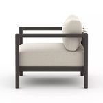 Side profile highlighting thickness of cushions and straight dark aluminum armrests on Sonoma Faye Sand Outdoor Chair