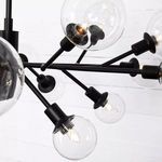 Close-up on several clear glass bulbs and matte black holders with visible glowing filaments