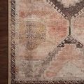 Close-up of Wynter rug corner showing geometric detailing and faded color effect
