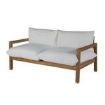 Three quarter front angle showing plush white cushions and teak frame with capped legs