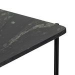 Close-up showing corner edge of polished black marble shelf with smooth finish and faint veining
