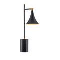 Straight-on view of lamp with illuminated matte black shade and cylindrical black marble base
