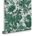 Rolled wallpaper showing Enzia Emerald pattern with visible edge and natural texture on white backing