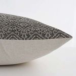 Side view showing tan patterned front and flax linen back of the pillow cover