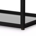 Close-up of black metal frame base lower corner with small protective foot detail