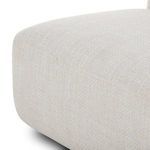 Close-up view of smooth front corner of the chaise cushion with beige performance fabric