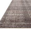 low angled side view showing thin flatweave edge and texture of muted plaid rug