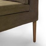 Close-up detail of wooden tapered leg and bottom corner upholstery stitching