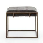 Front view emphasizing the tufting grid and cushion elevation above brass frame