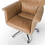 Close-up of seat cushion and armrest showing leather texture and stitching detail