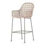 Side angle showing ergonomic wicker seat curve and metal frame footrest