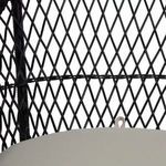 Detailed close-up of diamond pattern resin wicker backrest behind the top of beige cushion
