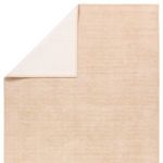 Top corner folded over revealing plain cream backing of the rug