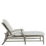 Side view of chaise with white cushions, backrest angled upright and thick padded cushions.