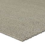close-up of textured braided fibers and edge binding in taupe and gray tones