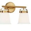 Side angle view of Kaden 2 Light Bath highlighting mounting arm and glass shade hardware