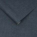 Navy blue Haptic wallpaper with plain, finely textured surface, shown rolled and flat