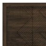 Extreme close-up of geometric embossed carved wood pattern on headboard with dark oak finish